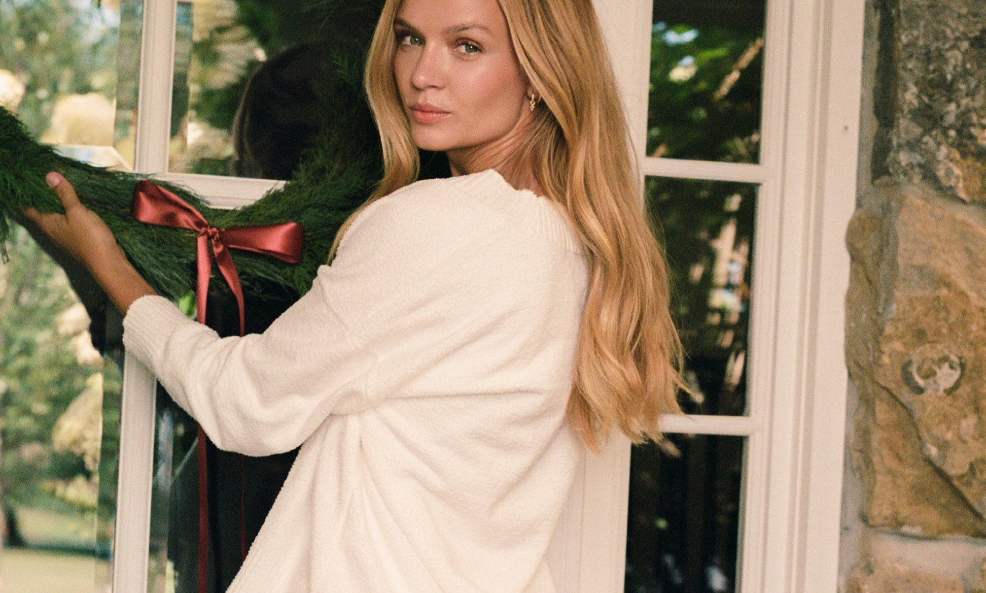 Model is wearing Recycled Boucle V Neck Pullover in Ivory
