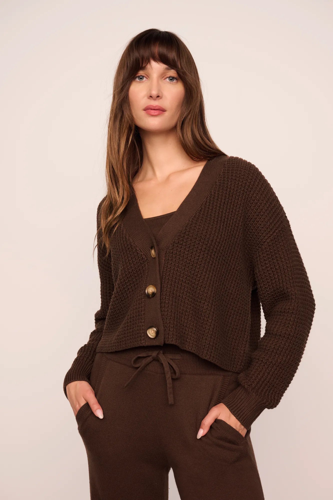 Model is wearing Recycled Sweater Cardigan in  Chocolate