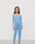 Model is wearing Kids TENCEL™ Modal Unisex Long PJ Set in Summer Blue/White