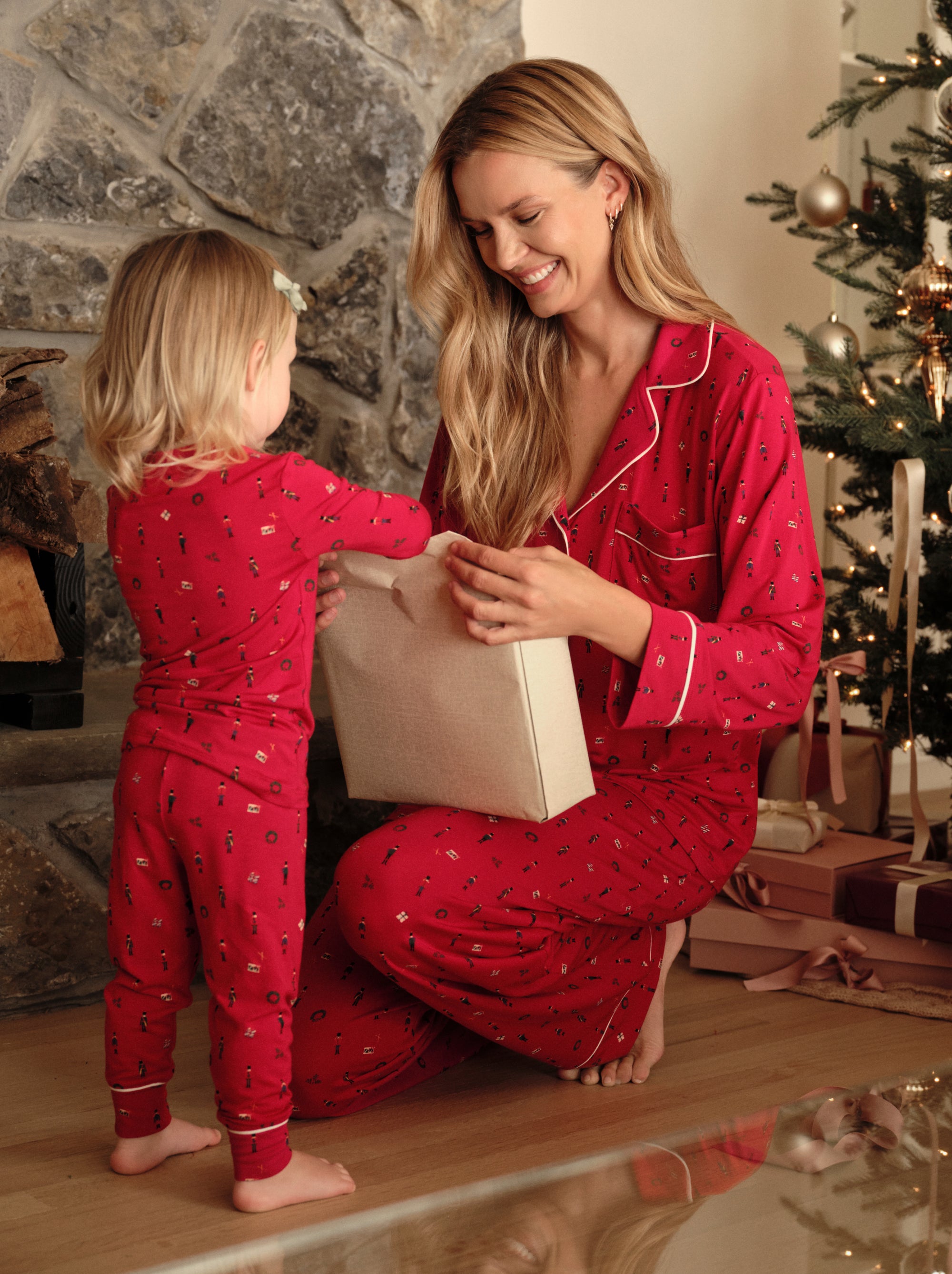 Family wearing matching printed PJs in Nutcracker Holly Red/Ivory
