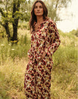 Model is wearing Inez Washable Silk Long PJ Set in Botanical Flower Merlot 