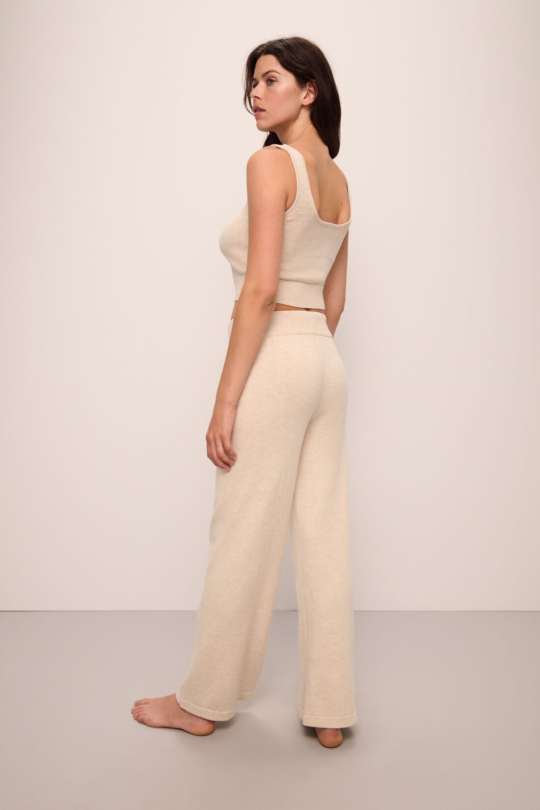 Model wears Recycled Sweater Pant in Oat.