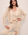 Model wears Recycled Sweater Cropped Cardigan in Oat.