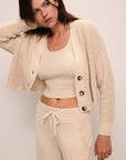 Model wears Recycled Sweater Cropped Cardigan in Oat.