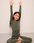 Model wears Kids TENCEL™ Modal Unisex Long PJ Set in moss/ivory.