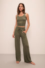 Model wears Recycled Sweater Pant in Moss.