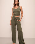 Model wears Recycled Sweater Pant in Moss.