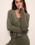 Model is Wearing the Recycled Sweater Cropped Cardigan in Moss.