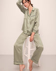 Model is wearing Inez Washable Silk Printed Long PJ Set in Geo Sphere Moss/Navy.