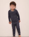 Model wears Kids TENCEL™ Modal Unisex Long PJ Set in Duo Stripe True Navy/Ivory.