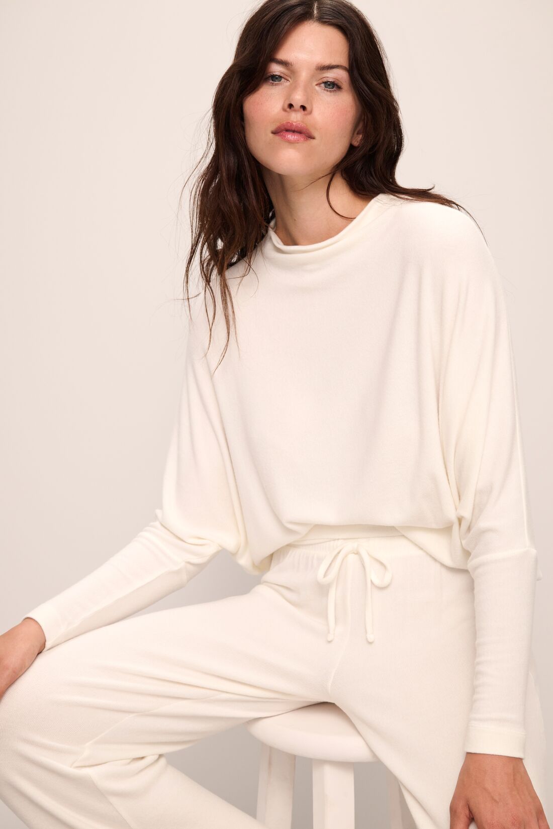 Model wears Cozy Time Mock Neck Pullover in Ivory.