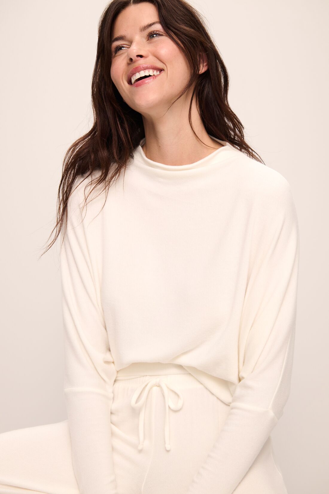 Model wears Cozy Time Mock Neck Pullover in Ivory.