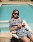 Model is wearing Eberjey x Casa Del Sol Inez Washable Silk Short PJ Set in Azulejos Navy/Navy