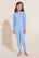 Model wears Kids Printed TENCEL™ Modal Unisex Long PJ Set in Nordic Stripes Vista Blue/Ivory.