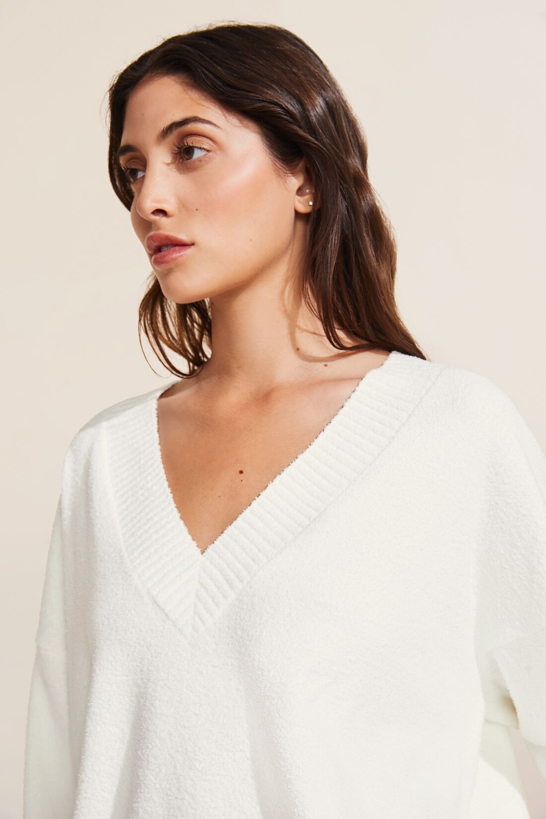 Model wears the Recycled Boucle Boyfriend Oversized V-Neck Sweater in Ivory.