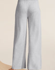 Model wears Recycled Sweater Pant in heather grey.