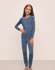 Model wears Kids TENCEL™ Modal Unisex Long PJ Set in Coastal Blue/Ice Blue.