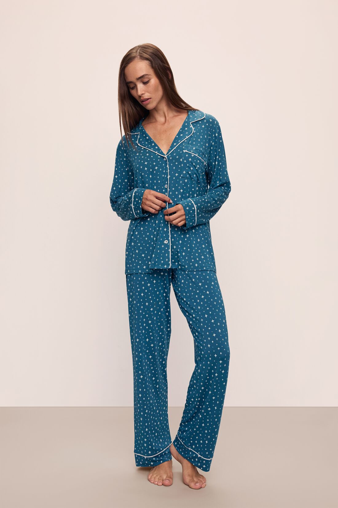 Model wears the Gisele Printed TENCEL™ Modal Long PJ Set in Festive Lights Sapphire/Ivory.