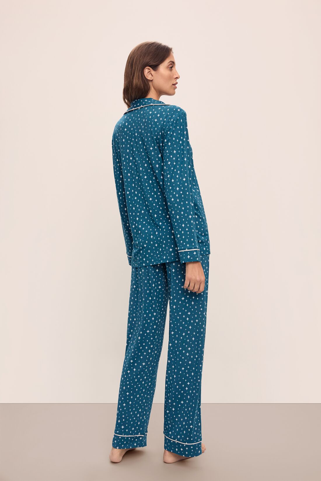 Model wears the Gisele Printed TENCEL™ Modal Long PJ Set in Festive Lights Sapphire/Ivory.