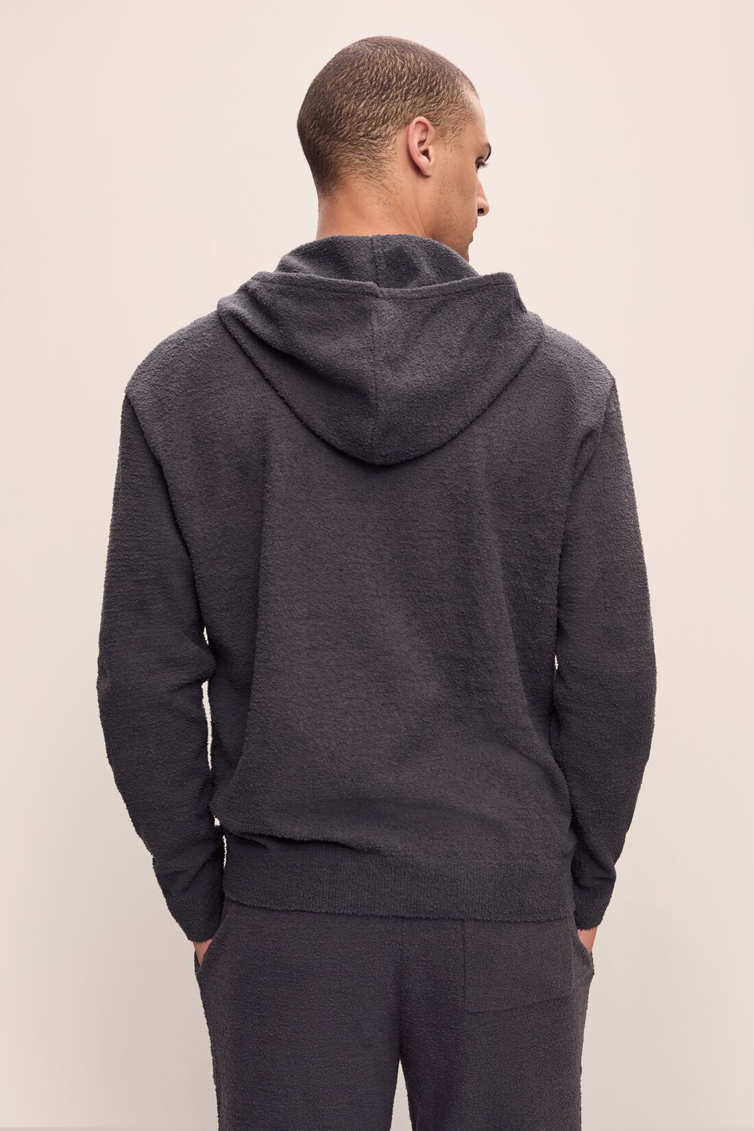 Model is wearing Men&#39;s Recycled Boucle Hoodie in Graphite.