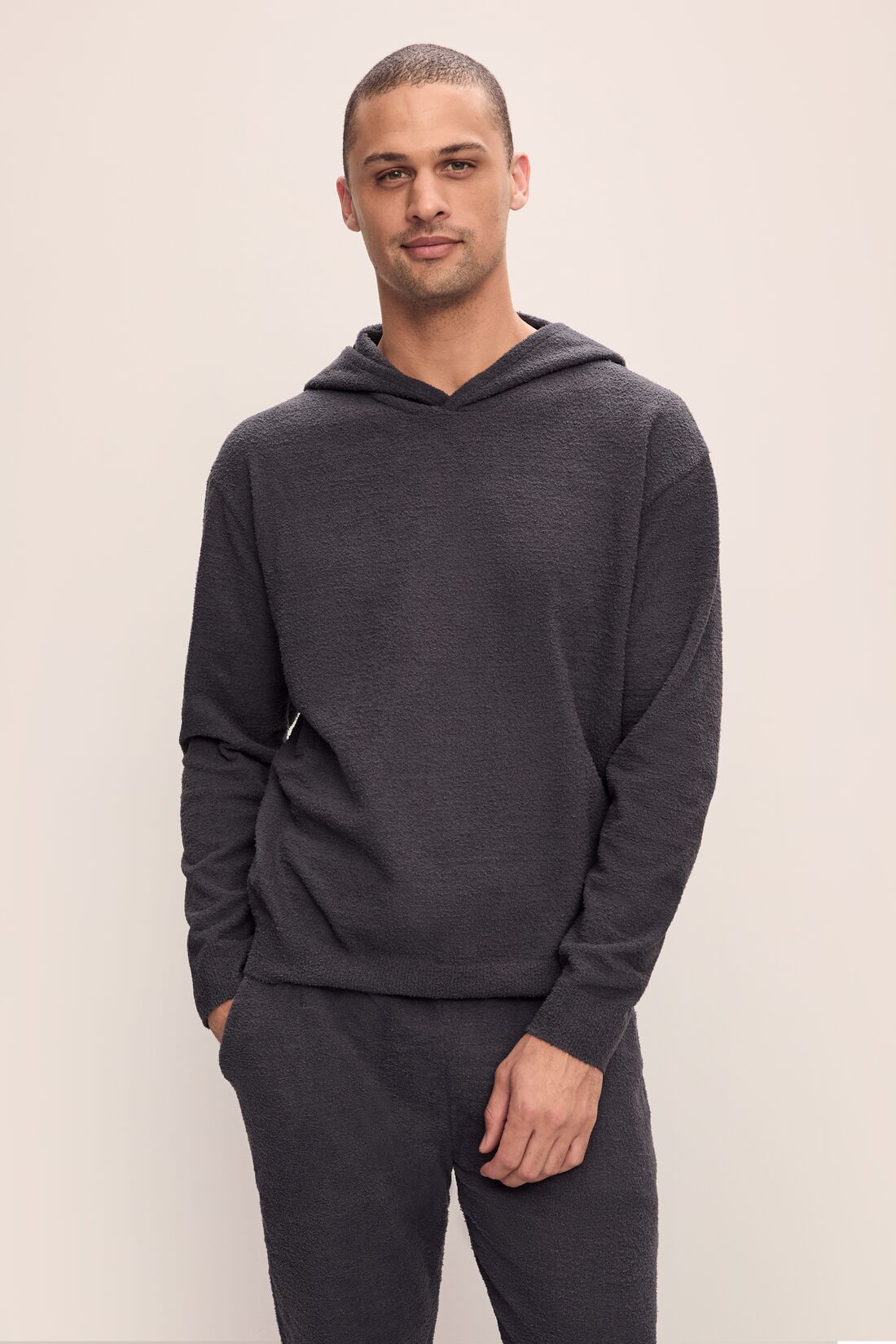 Model is wearing Men's Recycled Boucle Hoodie in Graphite.