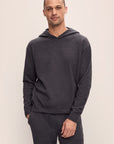 Model is wearing Men's Recycled Boucle Hoodie in Graphite.