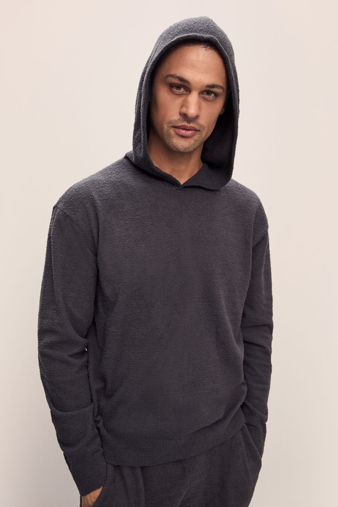 Model is wearing Men&#39;s Recycled Boucle Hoodie in Graphite.