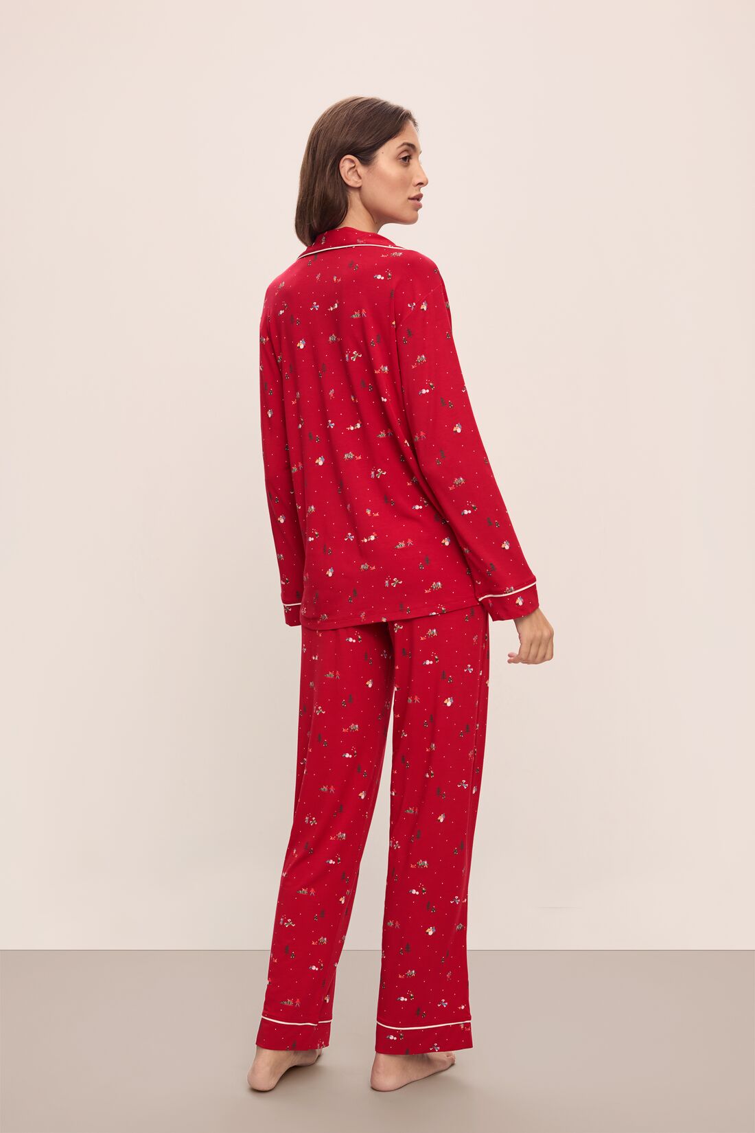 Model wears the Gisele Printed TENCEL™ Modal Long PJ Set in Winter Wonderland Haute Red/Ivory.