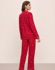 Model wears the Gisele Printed TENCEL™ Modal Long PJ Set in Winter Wonderland Haute Red/Ivory.