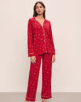 Model wears the Gisele Printed TENCEL™ Modal Long PJ Set in Winter Wonderland Haute Red/Ivory.