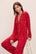 Model wears the Gisele Printed TENCEL™ Modal Long PJ Set in Winter Wonderland Haute Red/Ivory.