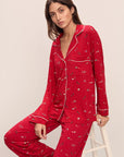 Model wears the Gisele Printed TENCEL™ Modal Long PJ Set in Winter Wonderland Haute Red/Ivory.