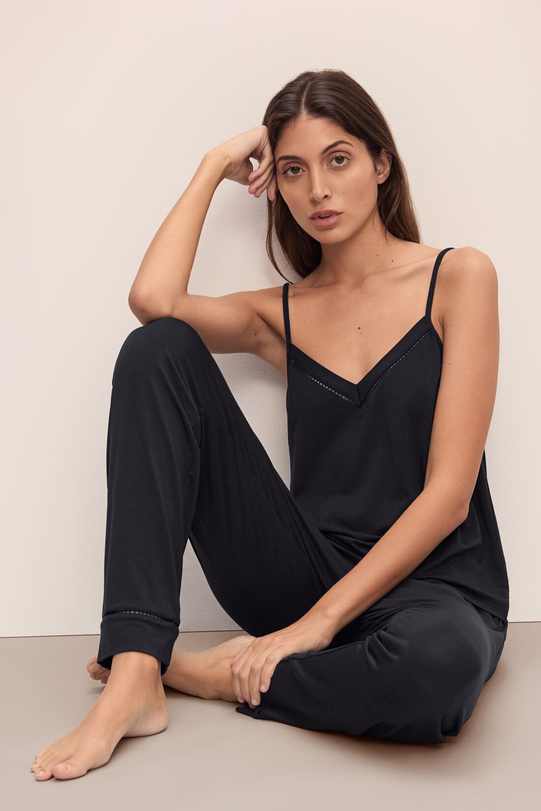 Model sitting wearing Fiona TENCEL™ Modal Cami &amp; Pant PJ Set in black.