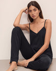 Model sitting wearing Fiona TENCEL™ Modal Cami & Pant PJ Set in black.