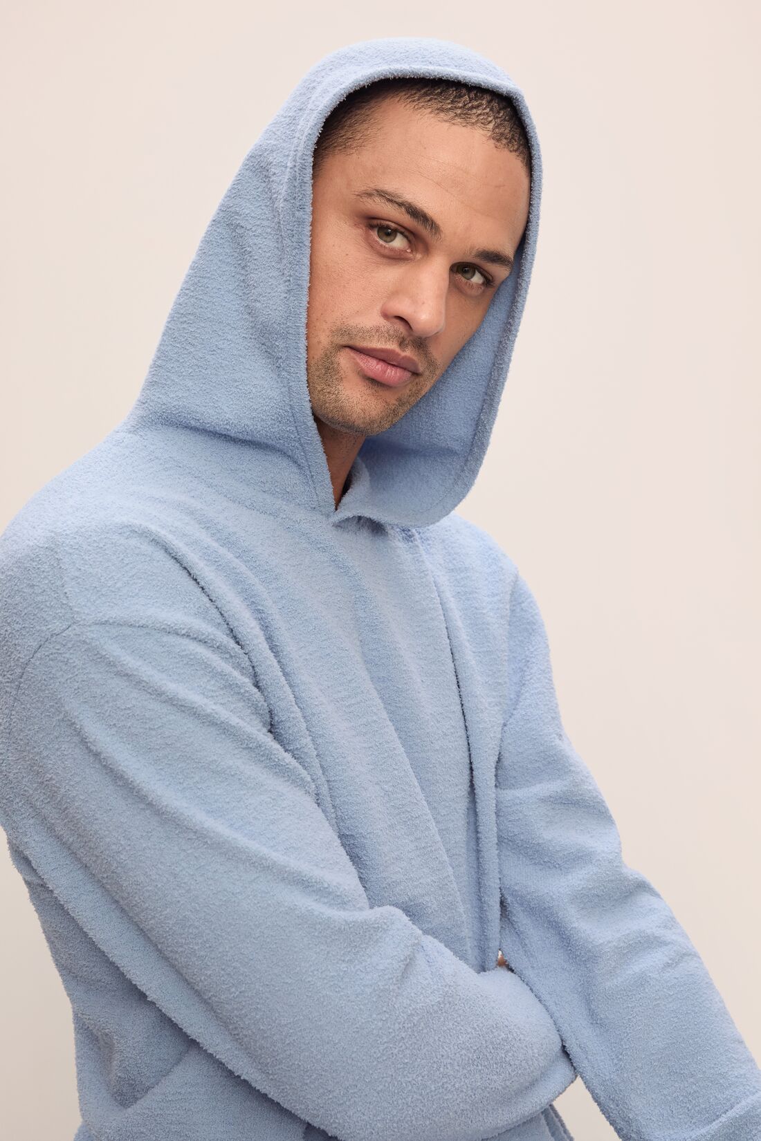 Model in Recycled Boucle Men&#39;s Hoodie in Wedgewood.