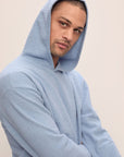 Model in Recycled Boucle Men's Hoodie in Wedgewood.