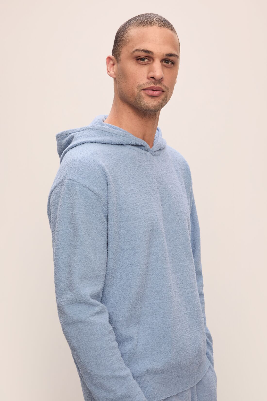 Model in Recycled Boucle Men's Hoodie in Wedgewood.