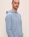 Model in Recycled Boucle Men's Hoodie in Wedgewood.