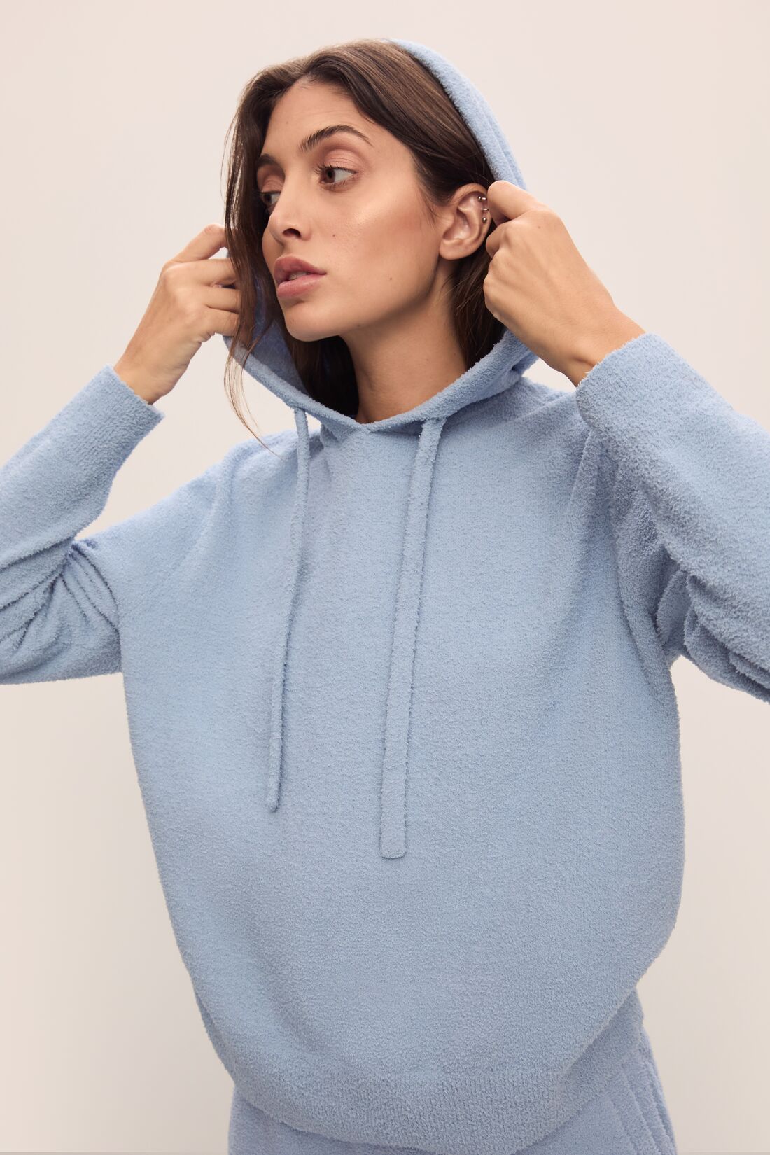 Model in Recycled Boucle Women&#39;s Hoodie and Jogger in Wedgewood.