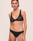 Model is wearing Soft Stretch Recycled Lace Thong in Black