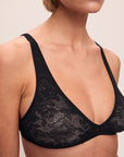 Model is wearing Soft Stretch Recycled Lace Triangle Bralette in Black