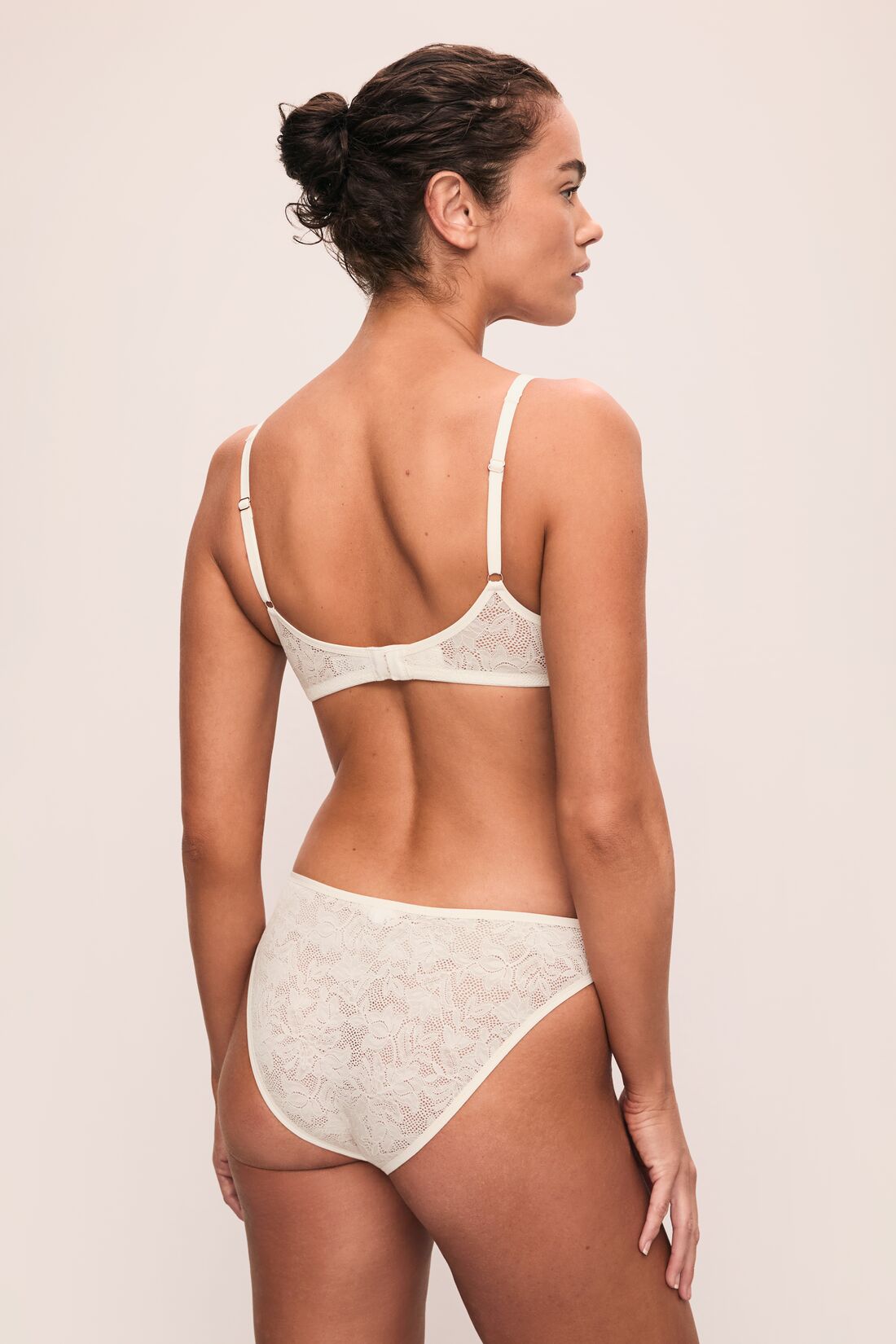 Model is wearing Soft Stretch Recycled Lace Triangle Bralette in Ivory