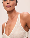 Model is wearing Soft Stretch Recycled Lace Triangle Bralette in Ivory