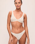 Model is wearing Soft Stretch Recycled Lace Triangle Bralette in Ivory