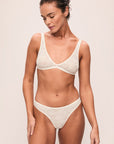 Model is wearing Soft Stretch Recycled Lace Thong in Ivory