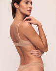 Model is wearing Soft Stretch Recycled Lace Thong in Sunkissed