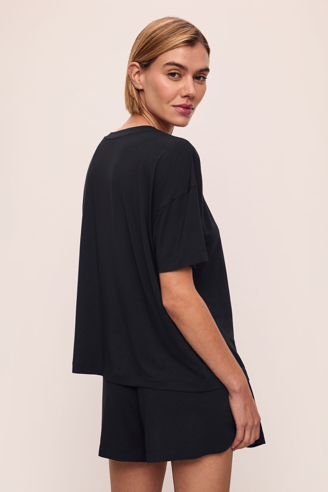 Model wears Gisele TENCEL™ Modal Everyday T-Shirt in black.