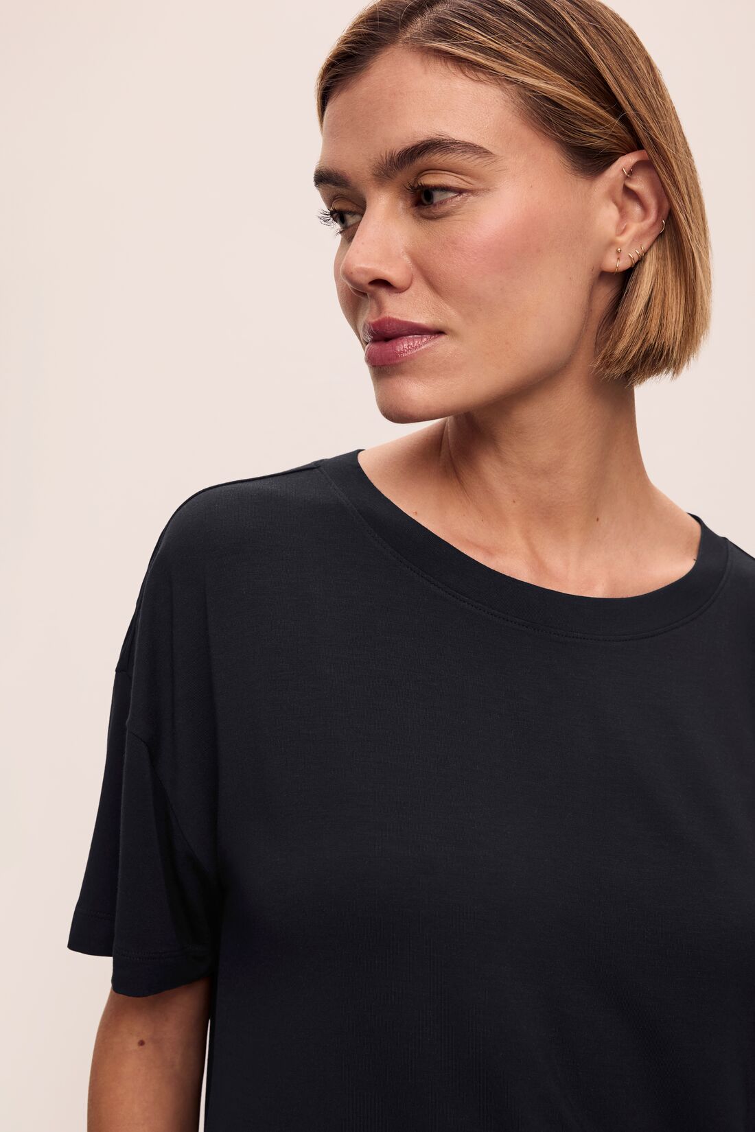 Model wears Gisele TENCEL™ Modal Everyday T-Shirt in black.