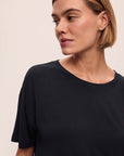 Model wears Gisele TENCEL™ Modal Everyday T-Shirt in black.