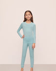 Model is wearing Kids Tencel™ Modal Unisex Long Pj Set in Canal Blue/Ivory